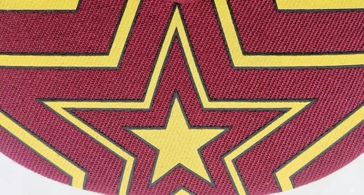 Bold yellow star and outlines screen printed on a maroon cap visor